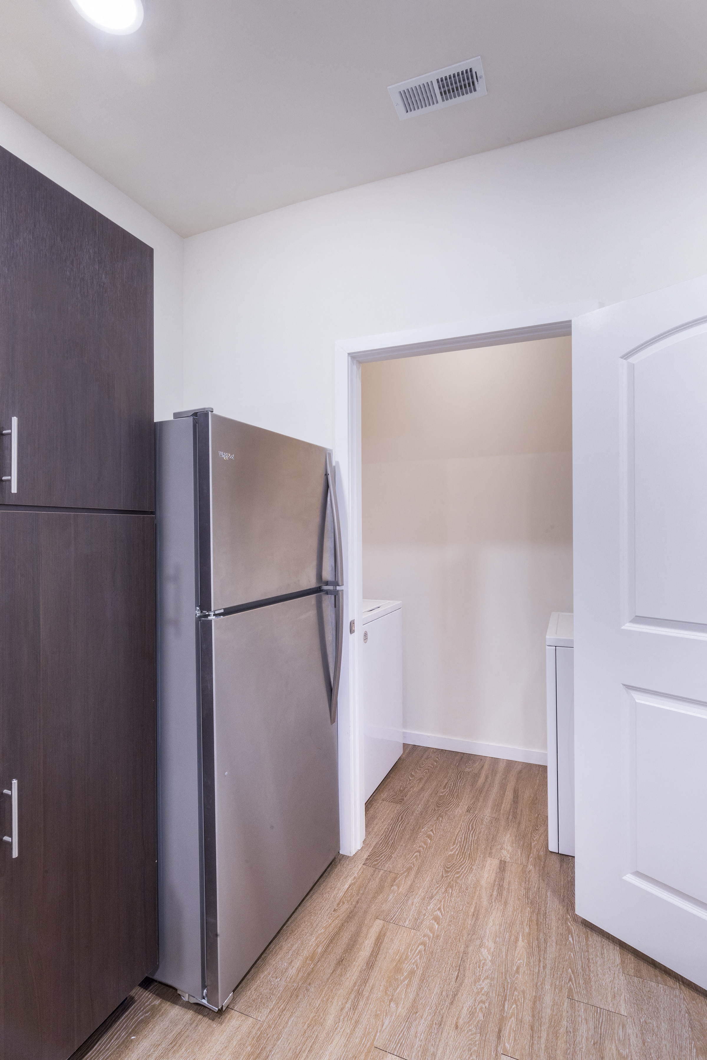 a kitchen with a refrigerator and a door to a closet at Aventura at Towne Centre, Ellisville, MO